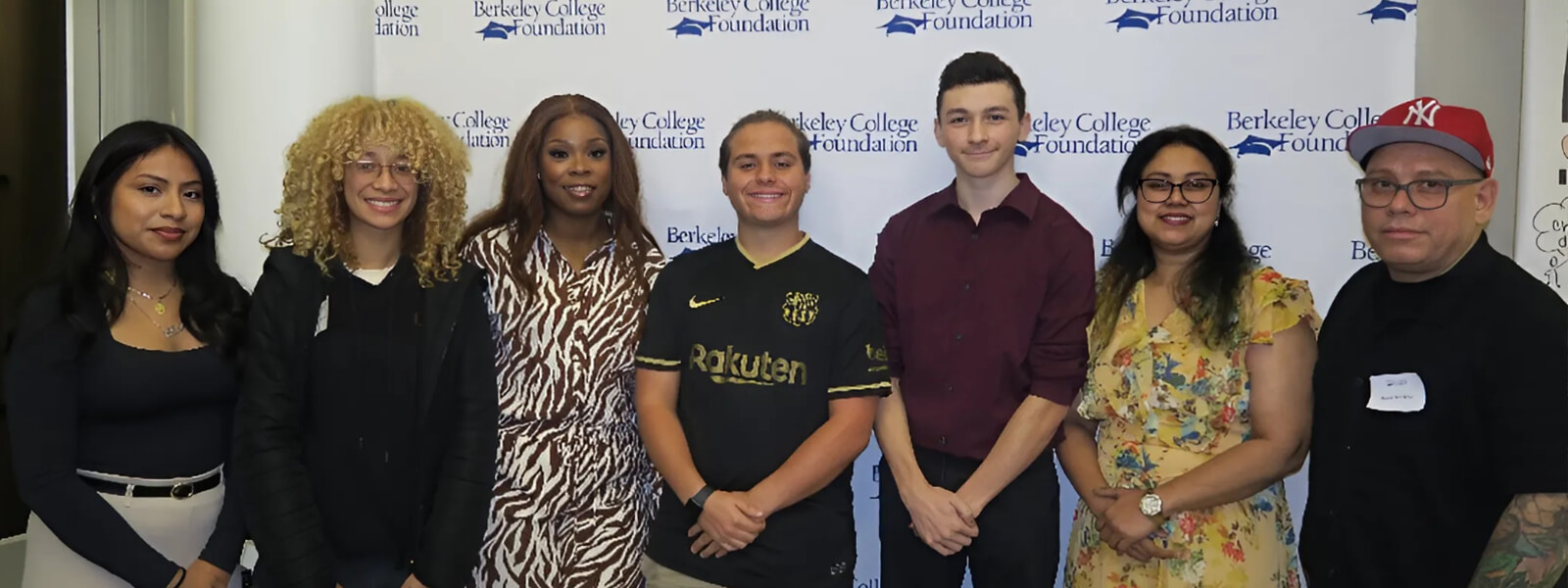 a group of students in front of a Berkeley College Foundation background