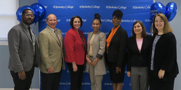 Multicultural business team standing together for a group picture at a corporate event