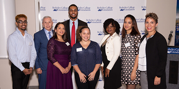 A diverse group of professionals smiling for a group photo at a business conference